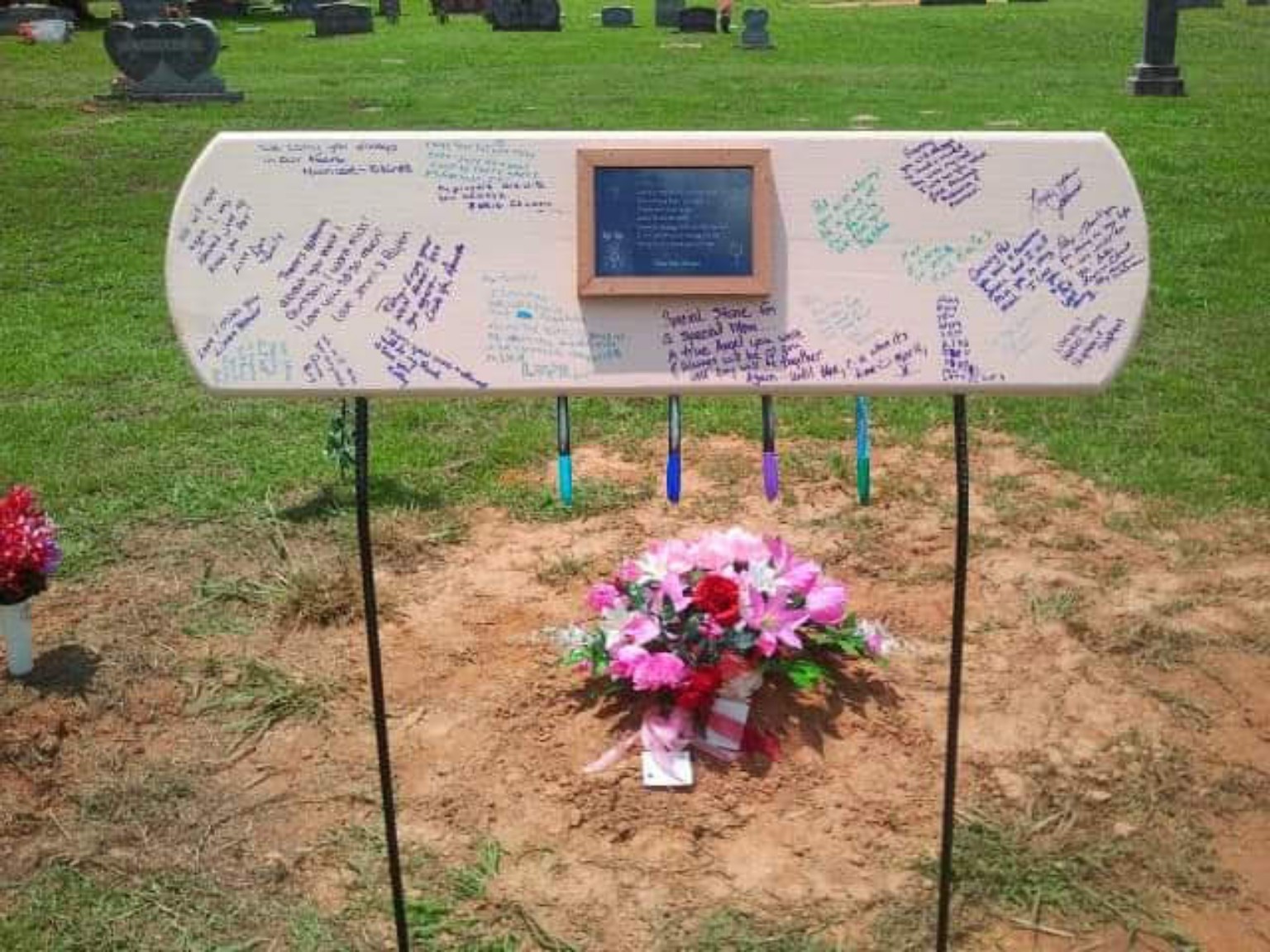 Complete installed Signing Stone with handwritten messages and hanging markers.